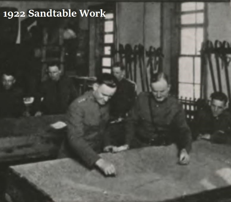Black and white image from 1922 of cadets doing sandtable work. 