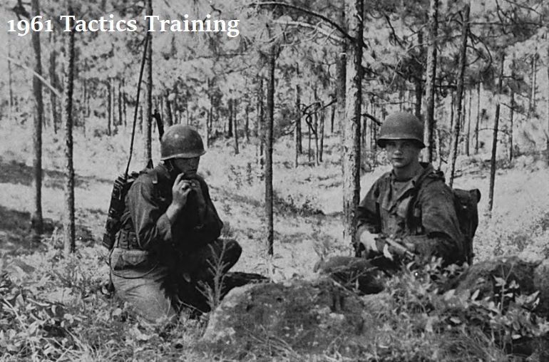 Black and white image of two cadets in the forest for 1961 tactics training.