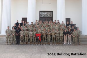 The 2025 Bulldog Battalion posing for a formation photo on stairs in front of a white building with columns. 