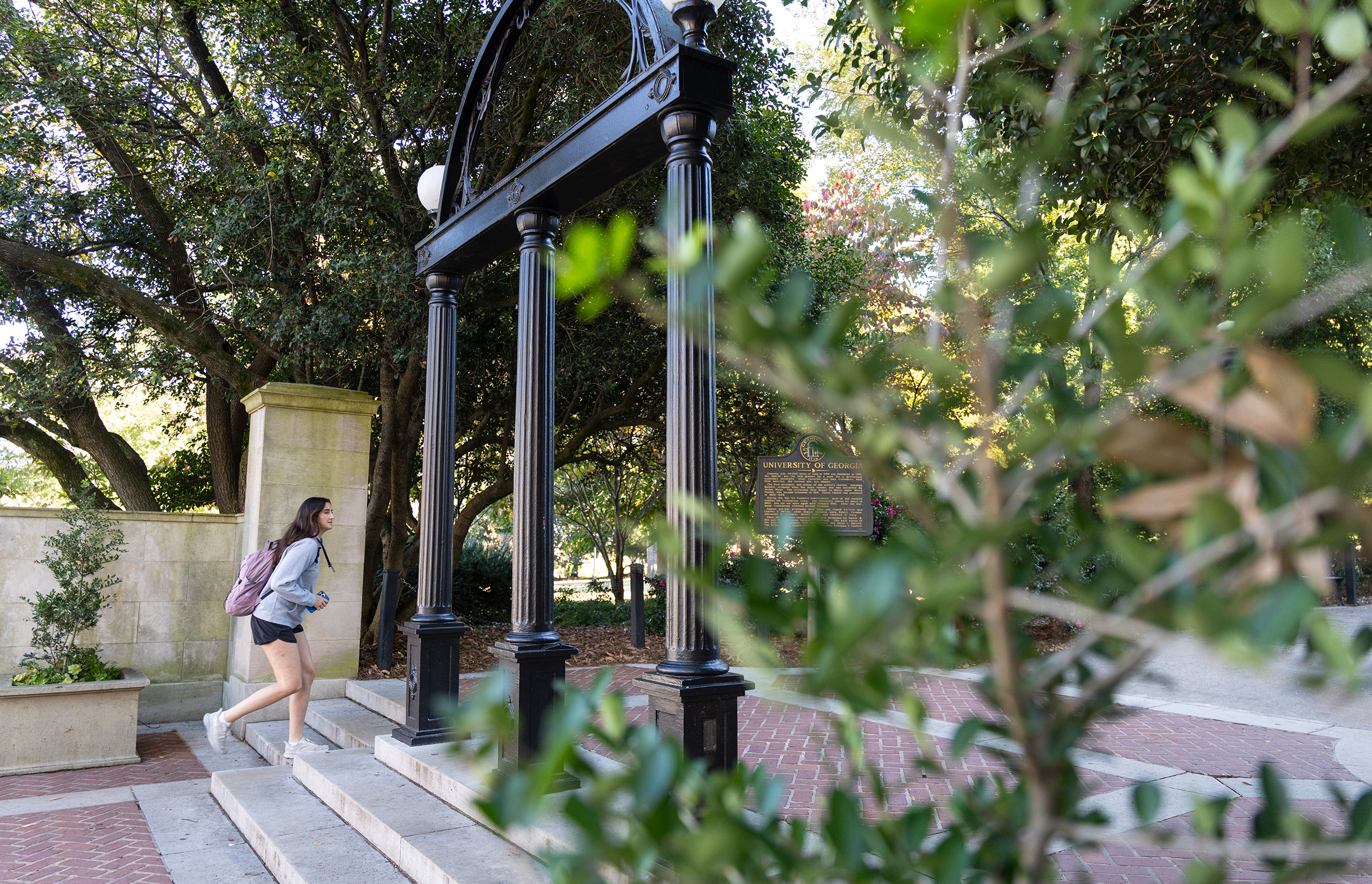 A student walks past the Arch onto North Campus
