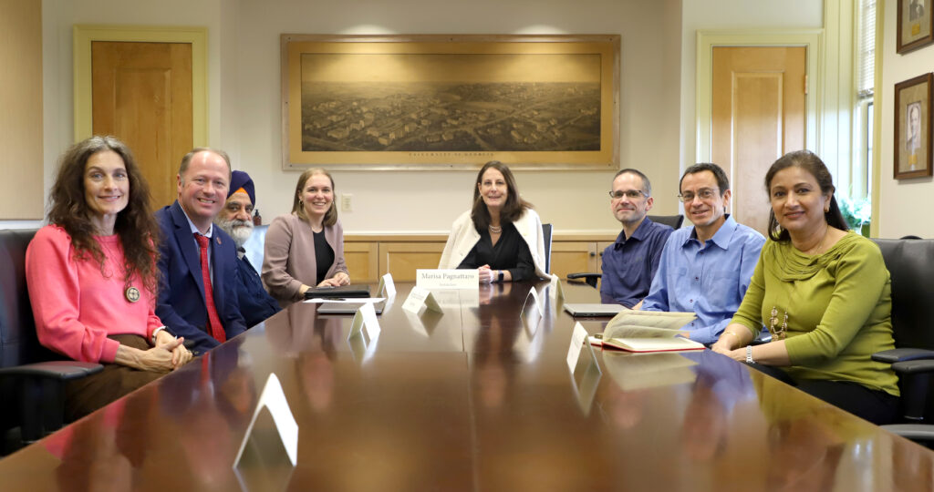 Faculty members at a conference table