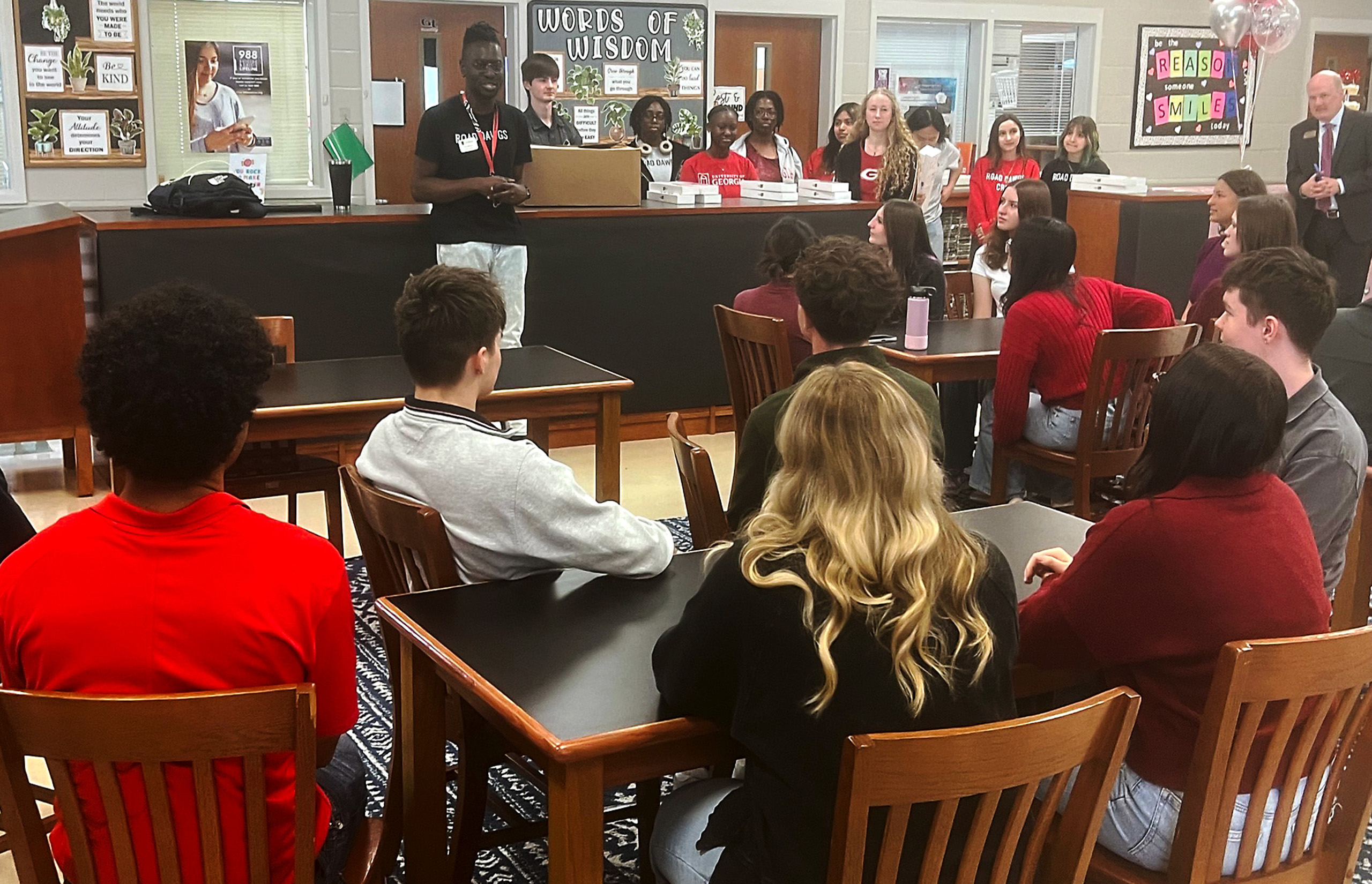 A UGA student talks to a room of high school students about the benefits of higher education during a Road Dawgs trip.
