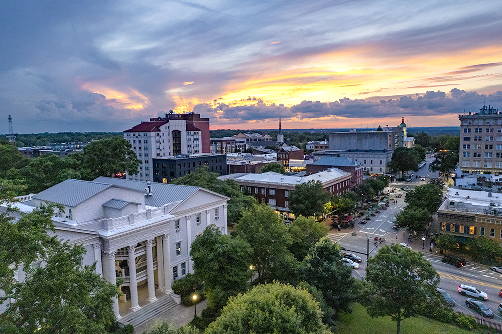 Summer overhead of the Holmes-Hunter Academic Building and downtown Athens, Georgia at sunset.