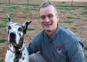 James Castle posing for a photo with his Great Dane, Quinn