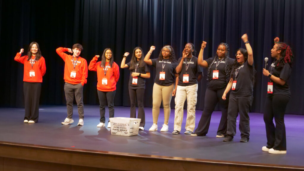 The 2024 Road Dawgs “Call the Dawgs” on stage at one of the high schools they visited over the week, hyping up the high school students before passing out UGA T-shirts.