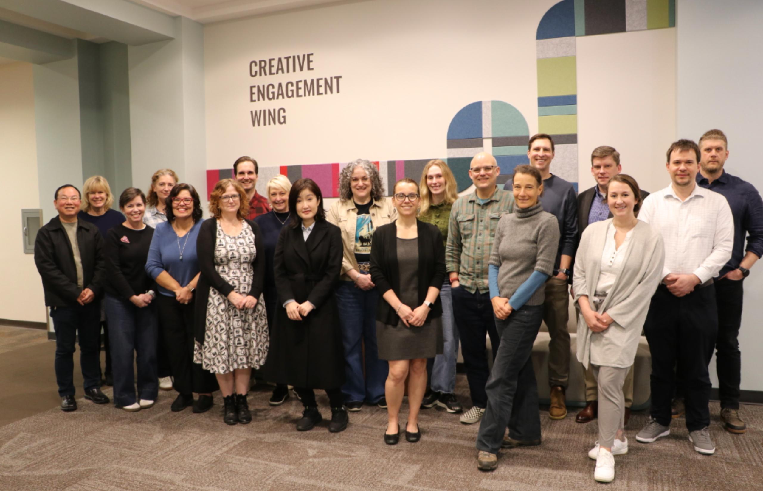 15 UGA faculty standing in front of the Creative Engagement Wing at the Miller Learning Center.