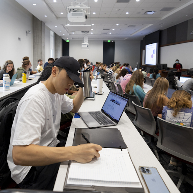 Undergraduate Minjae Kim, middle, takes notes as he listens to lecturer Harshani Rathnaweera on the first day of class in her Chemistry 1211 class in the new auditorium inside the ISTEM Research Building 2.
