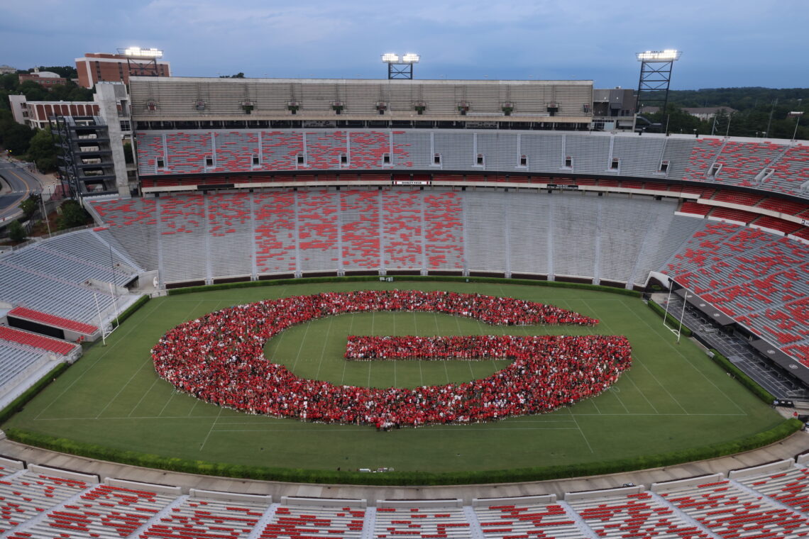 Students form the power G on the football field.